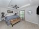 Spacious main bedroom with tray ceiling, ceiling fan and bench seat at 15232 Faulkner Ave, Port Charlotte, FL 33953