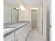 Bathroom featuring dual sinks, granite countertops, and modern fixtures adding a touch of elegance at 1565 Hyssop Loop, North Port, FL 34289