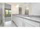 Bright bathroom featuring double sinks, granite countertops, and natural light at 1565 Hyssop Loop, North Port, FL 34289