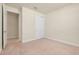 Neutral bedroom with carpet flooring, closet and open doorway at 1565 Hyssop Loop, North Port, FL 34289