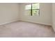 Carpeted bedroom with a large window offering plenty of natural light and pleasant views at 1565 Hyssop Loop, North Port, FL 34289