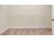 Spacious walk-in closet featuring wire shelving, providing ample storage space at 1565 Hyssop Loop, North Port, FL 34289