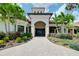 Community clubhouse with manicured landscaping and paved walkway at 1565 Hyssop Loop, North Port, FL 34289
