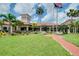 Community clubhouse with manicured landscaping, benches and paved walkway at 1565 Hyssop Loop, North Port, FL 34289