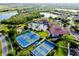 Aerial view showcases community amenities: tennis courts, pools, clubhouse, and surrounding lush landscaping at 1565 Hyssop Loop, North Port, FL 34289