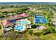 Aerial view featuring community amenities like tennis courts, a pool, and well-maintained landscaping at 1565 Hyssop Loop, North Port, FL 34289