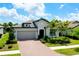 Charming single-Gathering home featuring a two-car garage and beautiful landscaping at 1565 Hyssop Loop, North Port, FL 34289