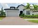 Charming single-Gathering home with a two-car garage and tropical landscaping at 1565 Hyssop Loop, North Port, FL 34289