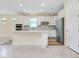 Modern kitchen with stainless steel appliances, island, recessed lighting and tiled floors at 1565 Hyssop Loop, North Port, FL 34289