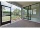 Screened lanai featuring brick floors and views of the backyard and interior space through sliding glass doors at 1565 Hyssop Loop, North Port, FL 34289