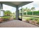 Enjoy the outdoors in this screened lanai featuring a brick floor and lush landscaping for privacy at 1565 Hyssop Loop, North Port, FL 34289