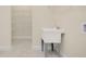 Spacious laundry room features a utility sink and ample storage shelves at 1565 Hyssop Loop, North Port, FL 34289