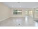 Spacious open-concept living room featuring recessed lighting, tiled flooring, and ample natural light at 1565 Hyssop Loop, North Port, FL 34289