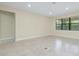 Spacious living room with tile flooring, natural light, and neutral paint, perfect for entertaining at 1565 Hyssop Loop, North Port, FL 34289