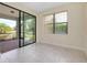 Living room with tile floors, sliding glass doors to the lanai, and a window offering views of the property at 1565 Hyssop Loop, North Port, FL 34289