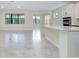 Spacious open-concept living area with tile flooring, neutral paint, and abundant natural light at 1565 Hyssop Loop, North Port, FL 34289