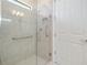 Clean bathroom shower features glass doors, grab bars and convenient niche for toiletries at 1565 Hyssop Loop, North Port, FL 34289