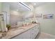 Bright bathroom featuring double sinks, granite countertops, and walk-in shower at 1608 Saddlewood Cir, Port Charlotte, FL 33953