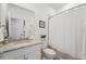 Well-lit bathroom with granite vanity, modern fixtures, and a shower featuring a rod and curtain at 1608 Saddlewood Cir, Port Charlotte, FL 33953