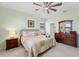 Well-lit bedroom with two windows, a large dresser, and a comfortable bed at 1608 Saddlewood Cir, Port Charlotte, FL 33953