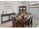 A view of the dining room showcasing table set for six, cabinet, and window at 1608 Saddlewood Cir, Port Charlotte, FL 33953