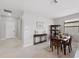 Neutral dining room showcasing a dark wood table set and a cabinet against a light-colored wall at 1608 Saddlewood Cir, Port Charlotte, FL 33953
