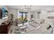 Spacious living area with comfortable seating, a ceiling fan, and sliding glass doors leading to the backyard at 1608 Saddlewood Cir, Port Charlotte, FL 33953