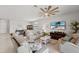 Relaxing living room with comfortable seating, large ceiling fan, and a view of the backyard at 1608 Saddlewood Cir, Port Charlotte, FL 33953