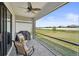 Relaxing screened patio with fan, outdoor furniture, and a grill overlooking the green backyard at 1608 Saddlewood Cir, Port Charlotte, FL 33953