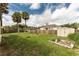 Large backyard with a storage shed, wooden fence, and ample green space, perfect for outdoor activities at 1609 Kirkwood St, North Port, FL 34288