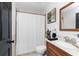 Bathroom features a shower with curtain, tile floors, and wood vanity at 1609 Kirkwood St, North Port, FL 34288