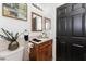 Bathroom with updated vanity, art, and fixtures plus dark wood door and tile floors at 1609 Kirkwood St, North Port, FL 34288