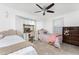 Charming bedroom with two beds, tile floors, ceiling fan and vanity with large mirror at 1609 Kirkwood St, North Port, FL 34288