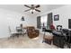 Spacious bedroom with ceiling fan and gaming setup near a bright window at 1609 Kirkwood St, North Port, FL 34288
