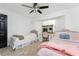 Bedroom with two beds, ceiling fan, tile floors and vanity with beautiful mirror at 1609 Kirkwood St, North Port, FL 34288