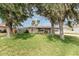 Charming single story home with mature trees and a manicured lawn in a quiet neighborhood at 1609 Kirkwood St, North Port, FL 34288