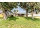 Inviting single-story home with a well-maintained lawn, mature trees, and an idyllic, peaceful setting at 1609 Kirkwood St, North Port, FL 34288