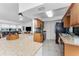 Well-lit kitchen featuring granite countertops, stainless steel appliances, and an adjacent breakfast bar at 1609 Kirkwood St, North Port, FL 34288