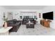 Inviting living room featuring a large bay window, tile floors, and a comfortable leather sofa set at 1609 Kirkwood St, North Port, FL 34288