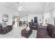 Open-concept living space with tile floors, comfortable seating, and a seamless flow into the dining area at 1609 Kirkwood St, North Port, FL 34288