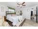 Bright main bedroom featuring a bed, bench seat, en suite bathroom and natural light at 1609 Kirkwood St, North Port, FL 34288