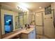 Bright bathroom with a glass-enclosed shower, modern fixtures, and a vanity with plenty of counter space at 1711 Gondola Park Dr # 1711, Venice, FL 34292