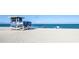 Scenic beach view with a lifeguard station, calm ocean, and a few beachgoers at 1711 Gondola Park Dr # 1711, Venice, FL 34292