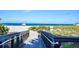 Boardwalk leading to the beach with lush vegetation, and a view of the ocean at 1711 Gondola Park Dr # 1711, Venice, FL 34292