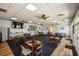 Spacious community dining area with multiple tables and chairs, complemented by ceiling fans and a TV at 1711 Gondola Park Dr # 1711, Venice, FL 34292