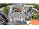 Aerial view of this stunning four-story condo complex with gray tile roof and garages at 1711 Gondola Park Dr # 1711, Venice, FL 34292
