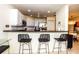 Kitchen with breakfast bar seating, modern appliances, and a stylish backsplash, open to dining area at 1711 Gondola Park Dr # 1711, Venice, FL 34292