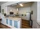 Well-lit kitchen featuring white cabinets, modern appliances, and a countertop bar with a light blue facade at 1711 Gondola Park Dr # 1711, Venice, FL 34292