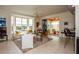Inviting living room with a bay window, neutral decor, and access to an outdoor balcony at 1711 Gondola Park Dr # 1711, Venice, FL 34292