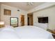Well-lit main bedroom featuring a large bed, walk-in closet access, dresser, and a view of the outside at 1711 Gondola Park Dr # 1711, Venice, FL 34292